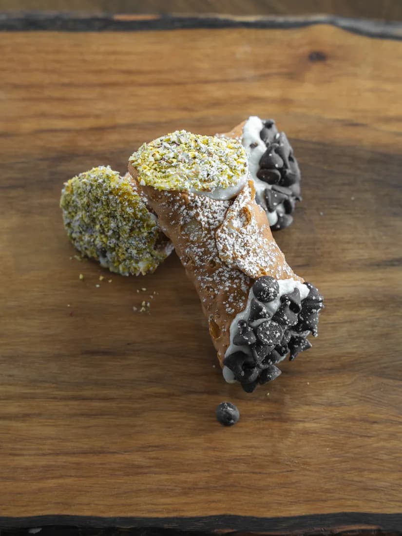 Classic Sicilian cannoli with mini chocolate chips and crushed pistachios, hand-piped for Kelowna weddings by Cannoli Bros